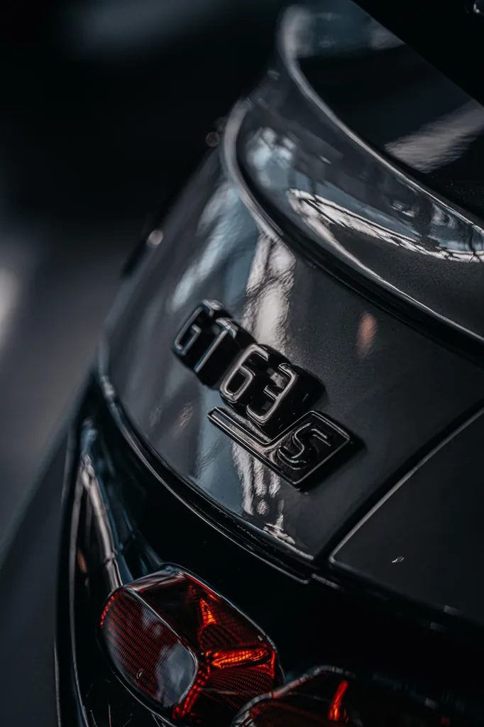 Close detail of a Mercedes-AMG badge and tail light