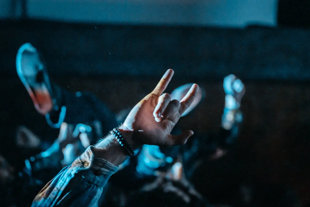 Raised hand in blue light at a concert