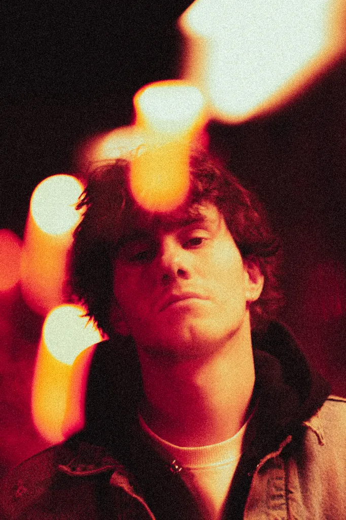 Close-up portrait lit in red with warm bokeh