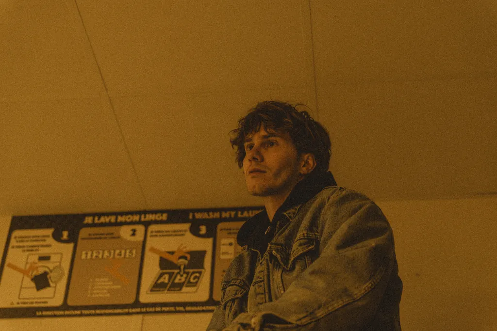 Environmental portrait in a laundromat, warm yellow light