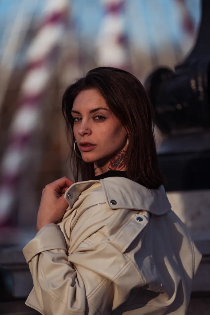 Woman in a white leather jacket in front of a ferris wheel